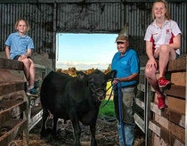 Noelle and Tayla Abbs with Peter Milton and Winston the 6th, the Angus Steer bought by the Abbs Family.